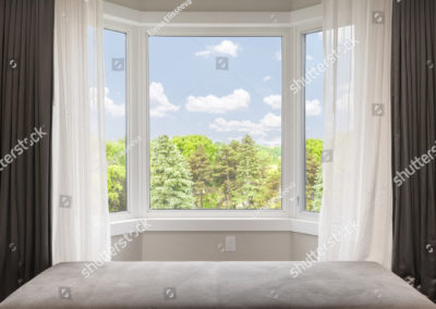 stock-photo-bay-window-with-drapes-curtains-and-view-of-trees-under-summer-sky-269761778